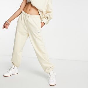 Nike Air Jordan essential fleece sweatpants in cream - size M